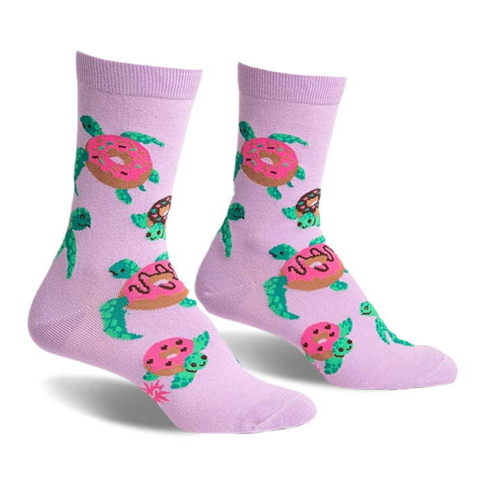 Pair of lavender crew socks with repeating pattern of turtles carrying pink donuts. Fun and quirky design.