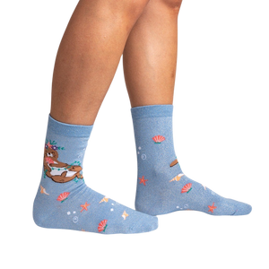 Lifestyle shot showing the 'Be Your-shell-f Shimmer' socks on a person's legs against a black background.