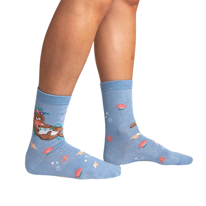 Lifestyle shot showing the 'Be Your-shell-f Shimmer' socks on a person's legs against a black background.