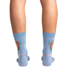 Rear view of the socks on a model's legs against a black background, showcasing the full design.