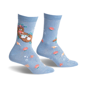 Pair of light blue crew socks with a whimsical design.  Features a flower-crowned otter, seashells, starfish, and subtle shimmer.