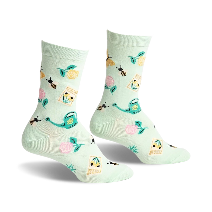 crew-length women's gardening socks with flower, bee, watering can, and seed packet patterns on a light green background.  