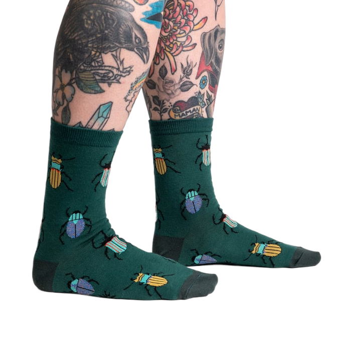 Lifestyle shot: Beetle-Mania! socks on a model's legs, showcasing the fit and design.