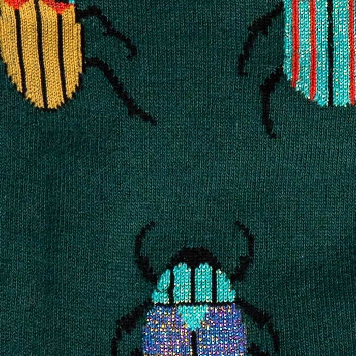 Close-up detail shot showing the colorful beetle pattern and texture of the socks.