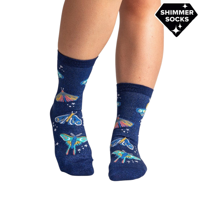 Lifestyle shot of a person's legs wearing the Moonlit Moth Shimmer socks, showing the socks on feet.