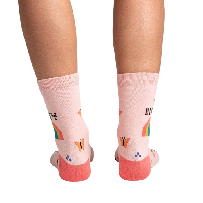 Back view of the socks on a model's legs, showcasing the design details on the back of the socks.