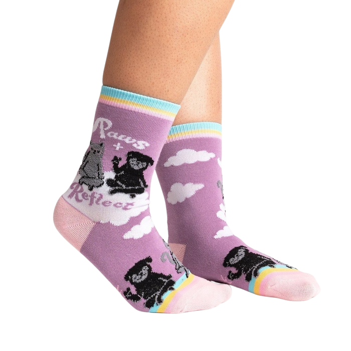 Lifestyle shot of Paws + Reflect socks on a person's legs, showcasing the sock's fit and design.