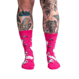 Lifestyle shot of a person's legs wearing Strawberry Milk socks, showcasing the socks on a model.