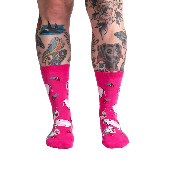 Lifestyle shot of a person's legs wearing Strawberry Milk socks, showcasing the socks on a model.