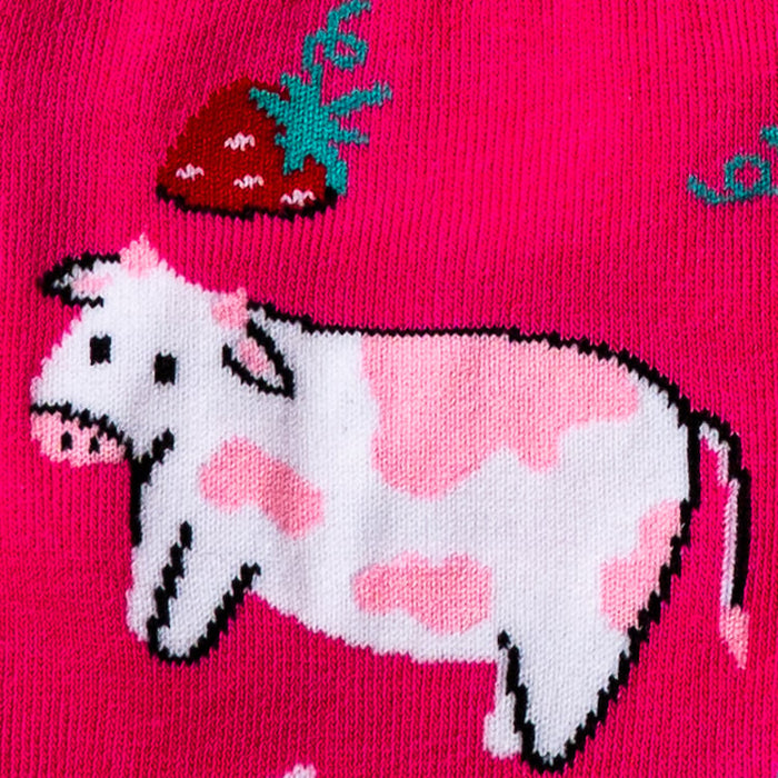 Close-up detail shot of a cow and strawberry design element from Strawberry Milk socks.