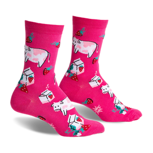 Pair of pink crew socks featuring illustrated cows, strawberries, and milk cartons. Fun, whimsical design.