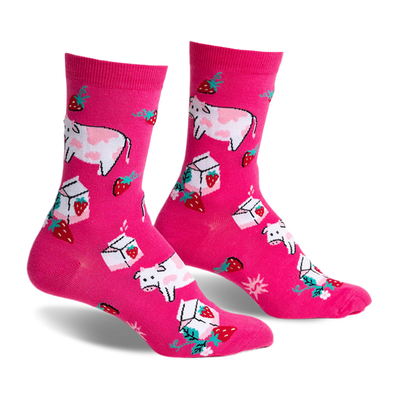 Pair of pink crew socks featuring illustrated cows, strawberries, and milk cartons. Fun, whimsical design.