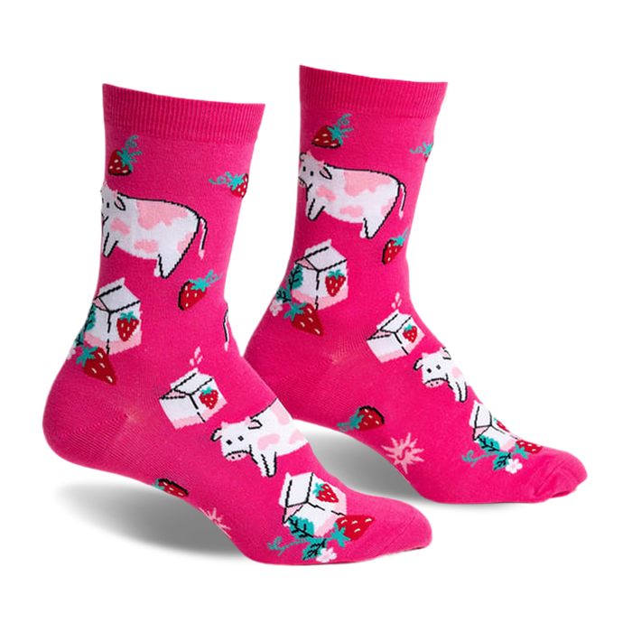 Pair of pink crew socks featuring illustrated cows, strawberries, and milk cartons. Fun, whimsical design.