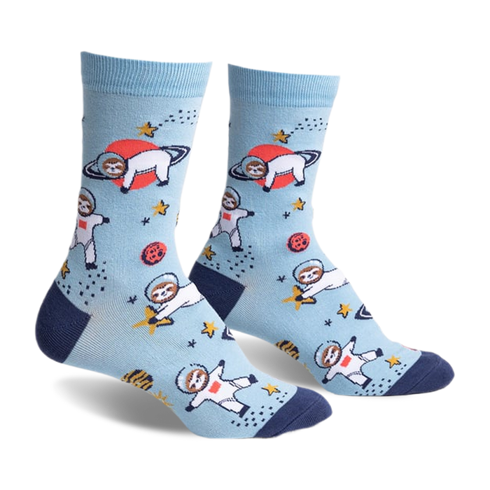 Pair of light blue crew socks with a fun design of sloths dressed as astronauts floating in space with planets and stars.