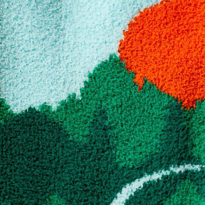 Close-up detail shot of the fuzzy fabric and mountain/sunset design of the slipper socks.