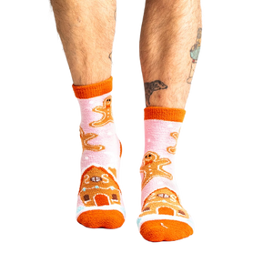 Lifestyle shot of a person wearing the pink gingerbread slipper socks.
