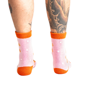 Back view of model wearing the pink and orange gingerbread socks.