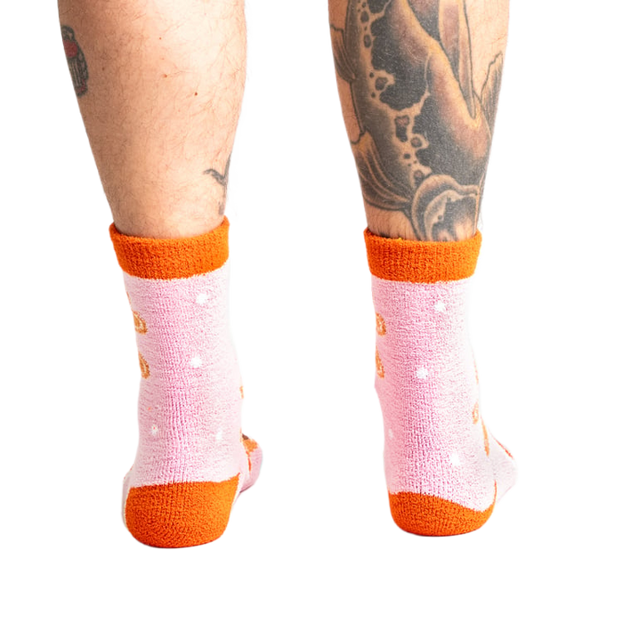 Back view of model wearing the pink and orange gingerbread socks.