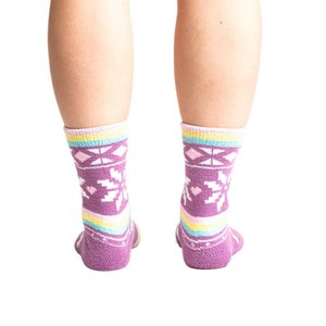 Rear view of socks on legs showing off the pastel stripes and snowflake design.