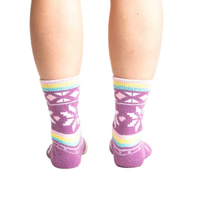 Rear view of socks on legs showing off the pastel stripes and snowflake design.