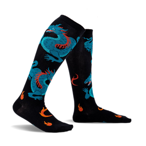Pair of black knee-high socks with teal dragons and orange flames. Fun and vibrant design.