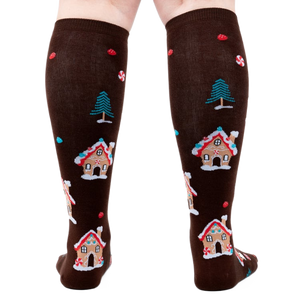 Back view of the socks on a person's legs showing the back of the design.