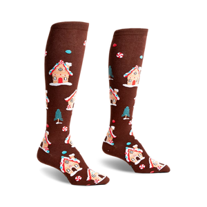Pair of brown knee-high socks with a whimsical pattern of gingerbread houses, candy canes, and small pine trees.