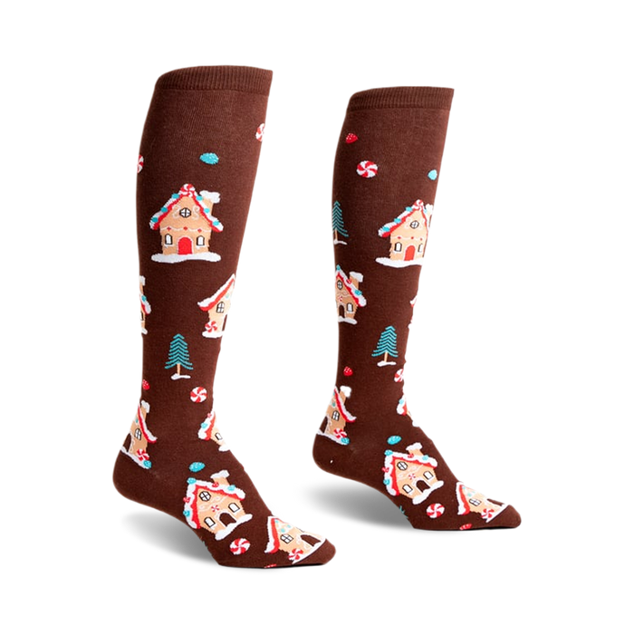 Pair of brown knee-high socks with a whimsical pattern of gingerbread houses, candy canes, and small pine trees.