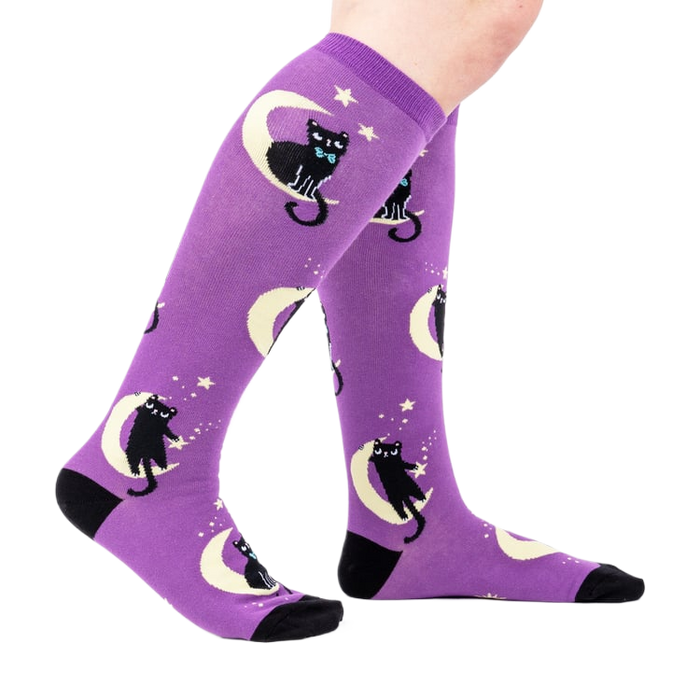 Lifestyle shot showing the socks on a person's legs, showcasing the fit and design.