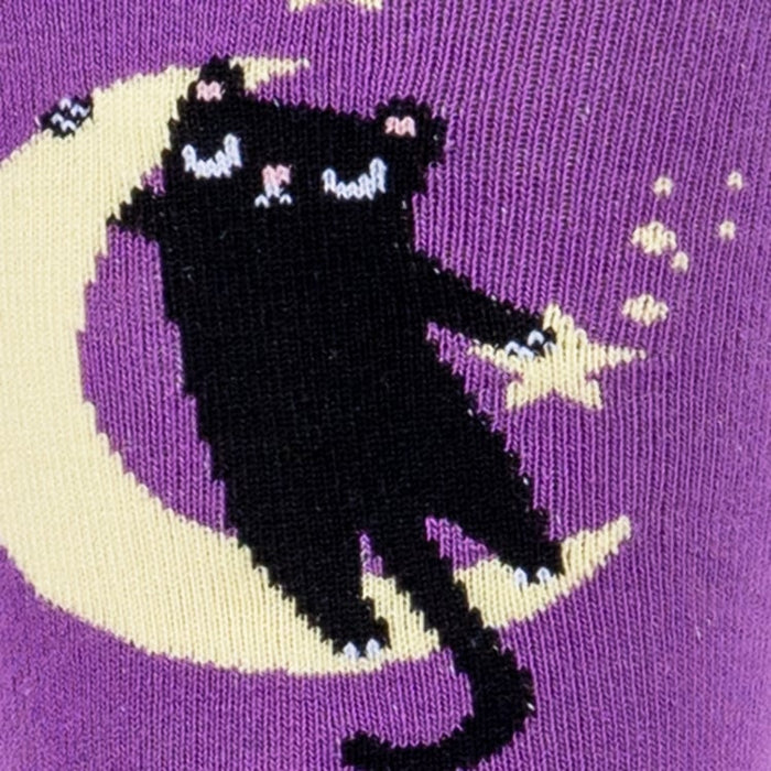 Close-up detail shot of the sock's design, focusing on a cat sitting on a moon.