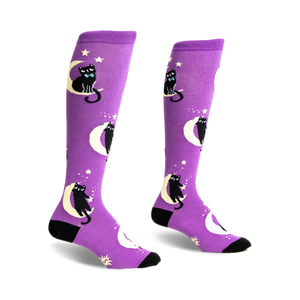 Pair of purple knee-high socks with black cats wearing bow ties sitting on crescent moons and stars.
