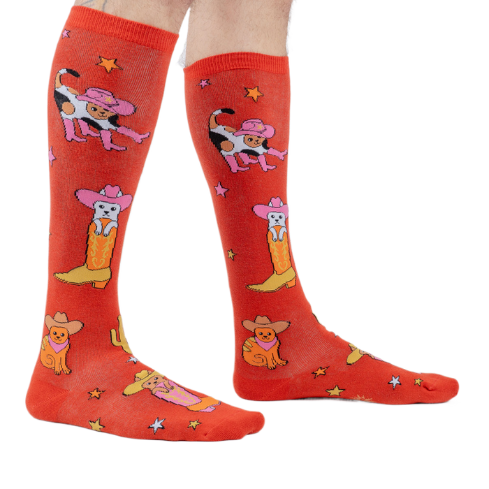 Lifestyle shot showing the 'Herding Cats' socks on a person's legs.