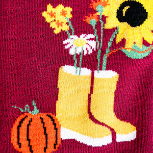 Close-up detail shot of Autumn Harvest sock design featuring yellow boots and a pumpkin.