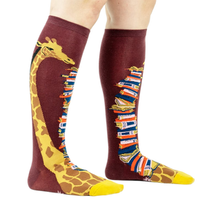 Knee-high socks on a model's legs, showcasing the giraffe and book design.