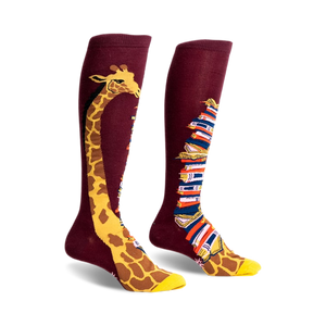 Pair of burgundy knee-high socks. One sock has a giraffe's neck & head; the other, a stack of colorful books.