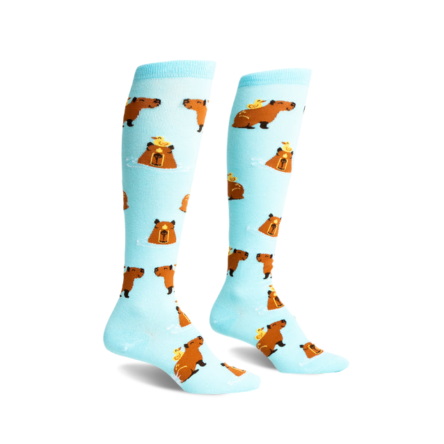 Pair of light blue knee-high socks with repeating pattern of brown capybaras and yellow ducklings. }}