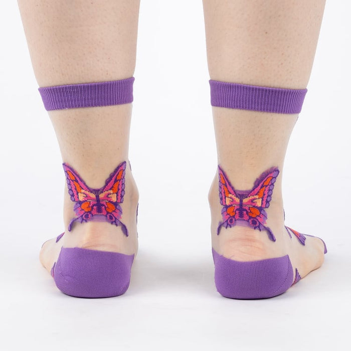 Close-up detail shot showcasing the butterfly design on the sheer sock fabric.