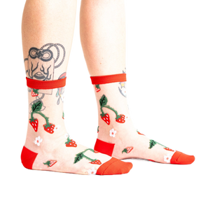 Pair of women's sheer ankle socks with a strawberry and flower design.  Red accents on the cuffs and toes complement the sheer mesh material.