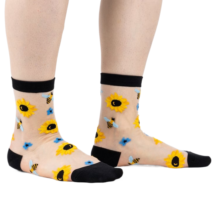 Alternative view of sheer socks with sunflowers and bees on a white background.