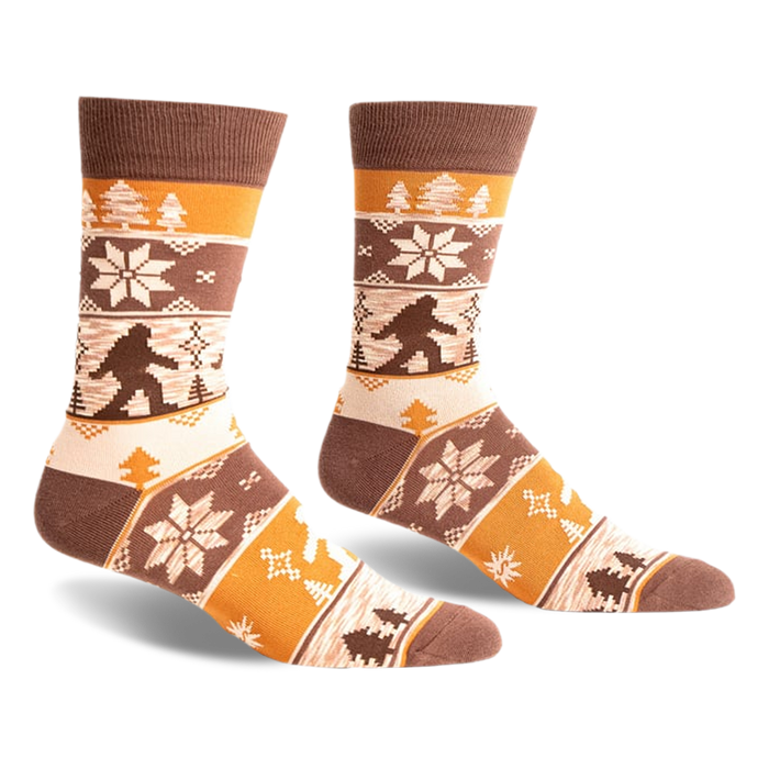 Brown, beige, and orange crew socks with a Bigfoot Fair Isle pattern.  Snowflakes and trees add to the wintery design.