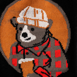 Close-up detail shot of the lumberjack bear design on the socks.