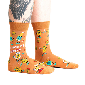 Lifestyle shot of a person wearing the 'Don't Worry, Be Hoppy' socks.