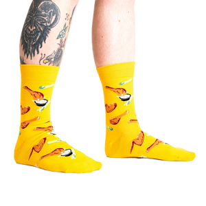 Lifestyle shot of a person wearing the yellow fried chicken socks.