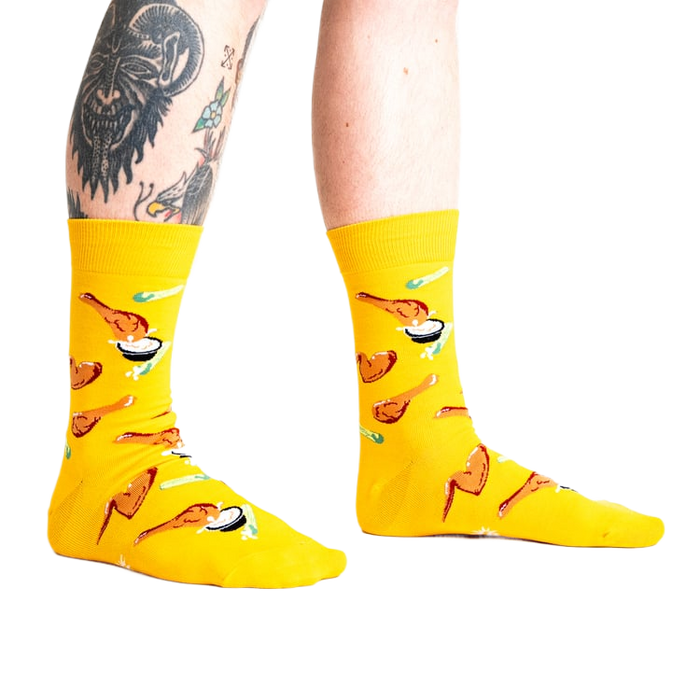 Lifestyle shot of a person wearing the yellow fried chicken socks.