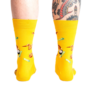 Rear view of the yellow fried chicken socks on a person's legs.