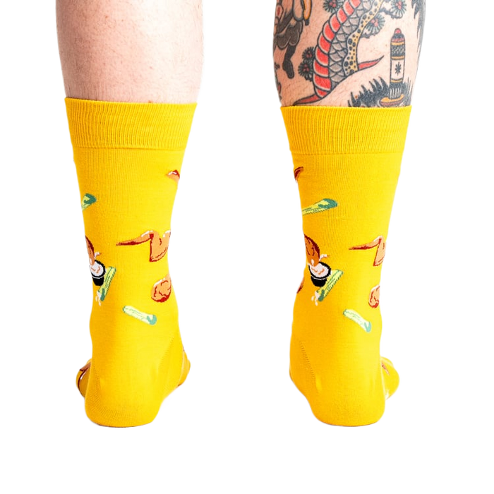 Rear view of the yellow fried chicken socks on a person's legs.