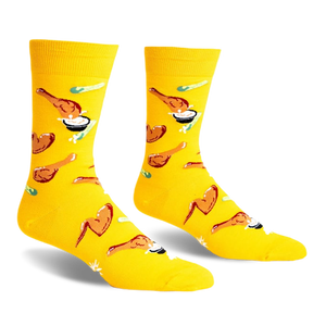 A pair of yellow crew socks with a fun pattern of fried chicken and dipping sauce.  The design is playful and colorful.