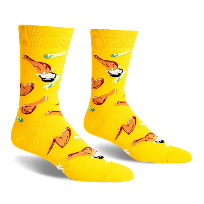 A pair of yellow crew socks with a fun pattern of fried chicken and dipping sauce.  The design is playful and colorful.