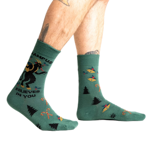 Lifestyle shot showing Krampus Believes in You socks on a person's legs.