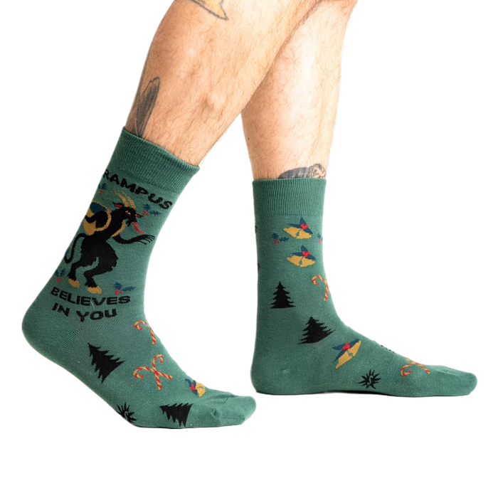Lifestyle shot showing Krampus Believes in You socks on a person's legs.